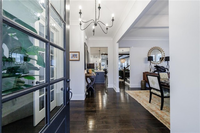 entrance foyer featuring dark hardwood / wood-style flooring, ornamental molding, french doors, and a notable chandelier