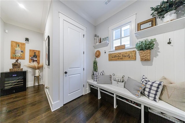 mudroom with dark hardwood / wood-style flooring and ornamental molding