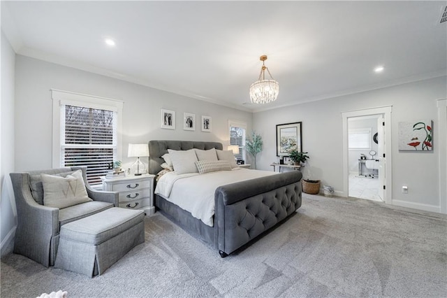 carpeted bedroom with connected bathroom, an inviting chandelier, and ornamental molding