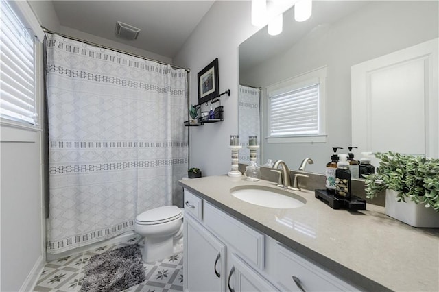 bathroom featuring curtained shower, vanity, and toilet