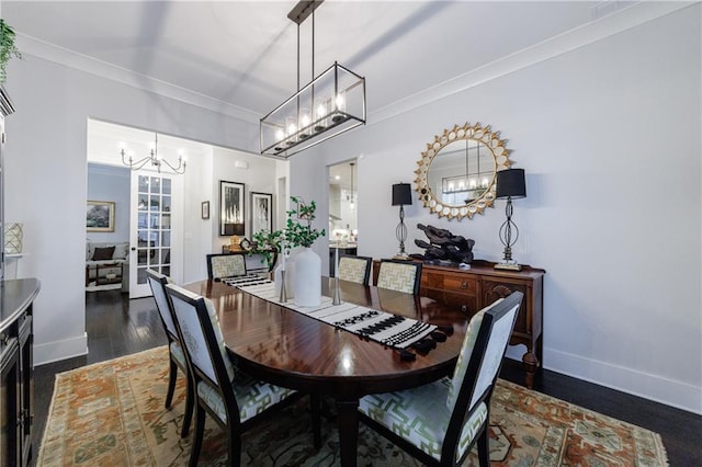 dining space with dark hardwood / wood-style flooring and ornamental molding