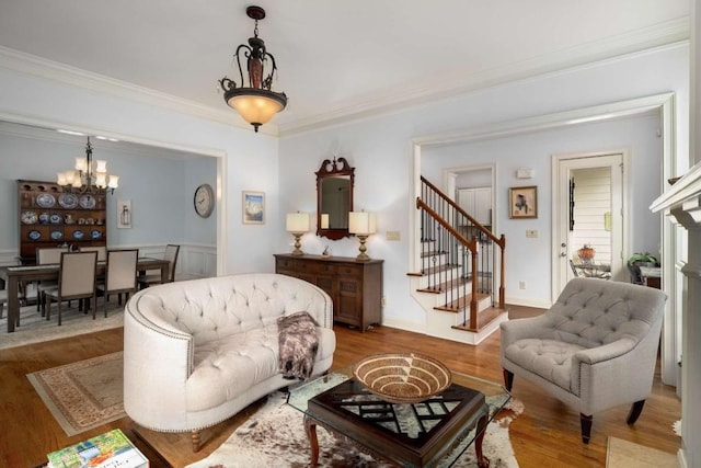 living room featuring a notable chandelier, crown molding, and hardwood / wood-style floors