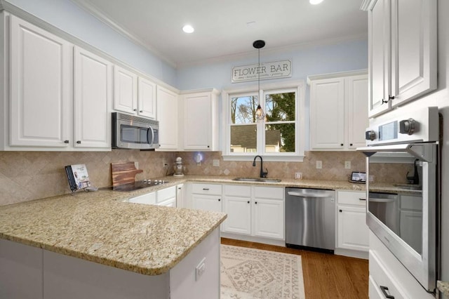 kitchen with sink, appliances with stainless steel finishes, and white cabinetry