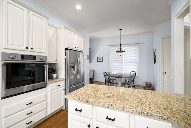 kitchen featuring white cabinetry, light stone counters, dark hardwood / wood-style floors, pendant lighting, and appliances with stainless steel finishes