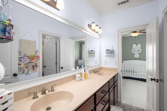 bathroom featuring ornamental molding, ceiling fan, and vanity