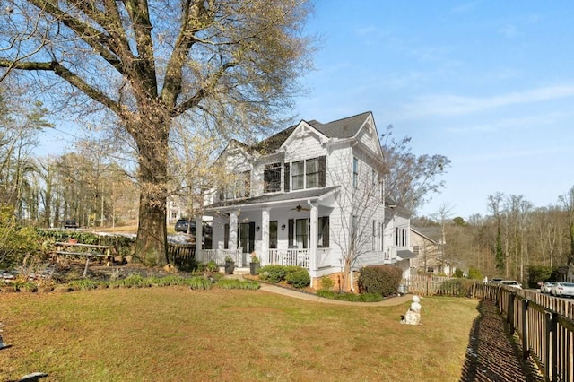 exterior space featuring covered porch and a lawn