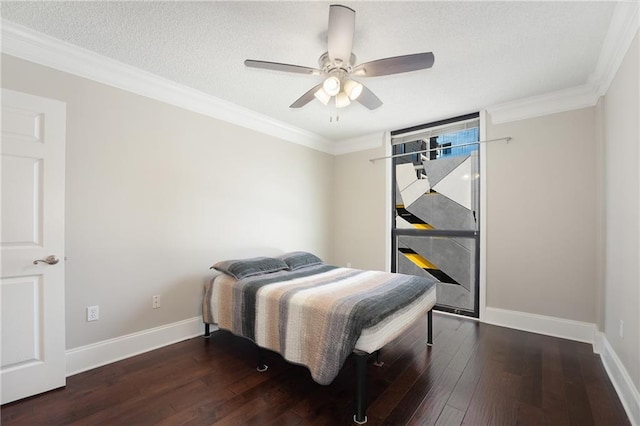 bedroom with ceiling fan, dark hardwood / wood-style floors, and ornamental molding