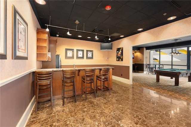 bar with stainless steel fridge, track lighting, hanging light fixtures, and pool table