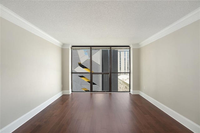 spare room featuring crown molding, dark hardwood / wood-style flooring, a textured ceiling, and a wall of windows