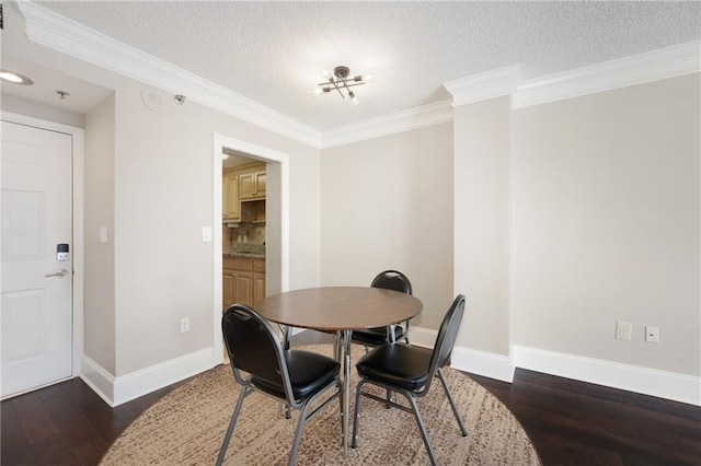 dining space with dark hardwood / wood-style floors, a textured ceiling, and ornamental molding