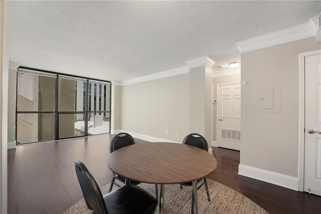 interior space featuring ornamental molding, a textured ceiling, and dark wood-type flooring