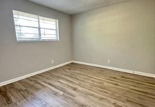 spare room with hardwood / wood-style floors