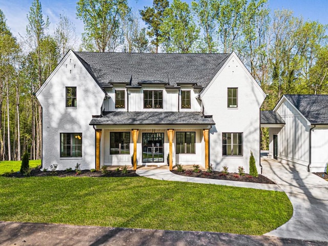 view of front of house with a porch and a front yard