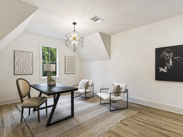 living area featuring a notable chandelier, vaulted ceiling, and dark hardwood / wood-style floors