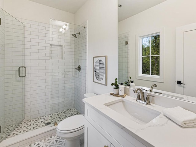 bathroom with vanity, toilet, and walk in shower