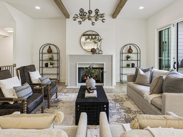 living room with beam ceiling, light wood-type flooring, and a notable chandelier