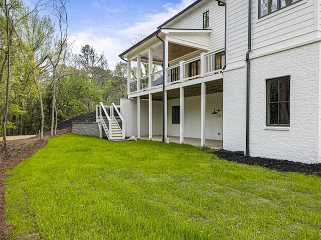 exterior space featuring a wooden deck and a lawn