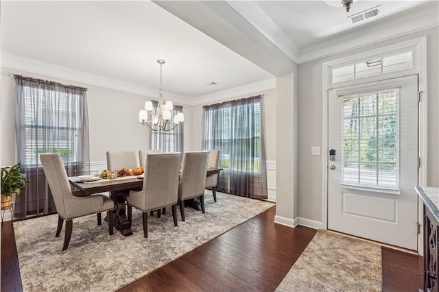 4050 Danbury Farms Dr, Cumming, GA 30040 - dining area featuring visible vents, dark wood-style floors, a notable chandelier, and crown molding