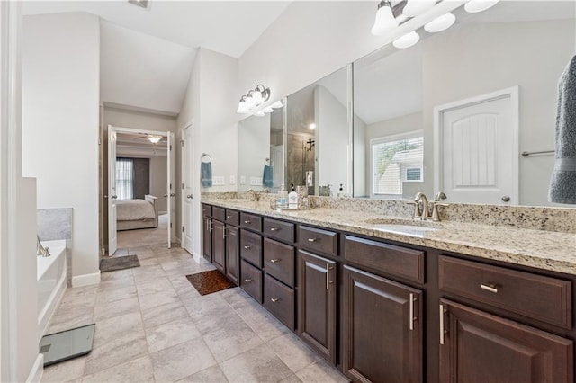 4050 Danbury Farms Dr, Cumming, GA 30040 - ensuite bathroom featuring vaulted ceiling, a sink, and double vanity