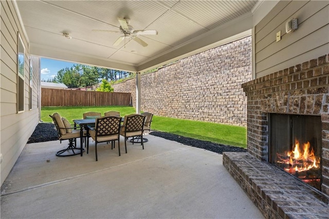 4050 Danbury Farms Dr, Cumming, GA 30040 - view of patio / terrace featuring fence, an outdoor brick fireplace, a ceiling fan, and outdoor dining space