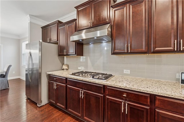 4050 Danbury Farms Dr, Cumming, GA 30040 - kitchen with light stone counters, under cabinet range hood, stainless steel appliances, dark wood finished floors, and ornamental molding