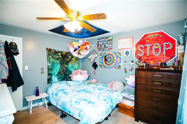 bedroom with ceiling fan and light hardwood / wood-style floors