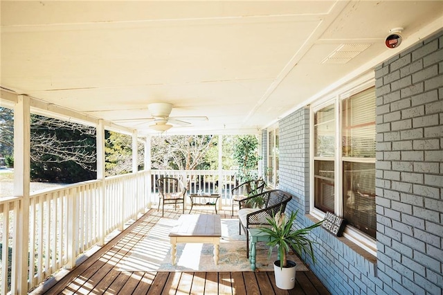 wooden terrace with ceiling fan and a porch