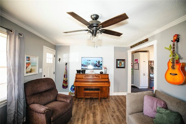 living room featuring dark hardwood / wood-style flooring, ornamental molding, and ceiling fan