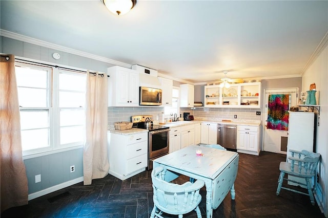 kitchen with appliances with stainless steel finishes, white cabinetry, and dark parquet flooring