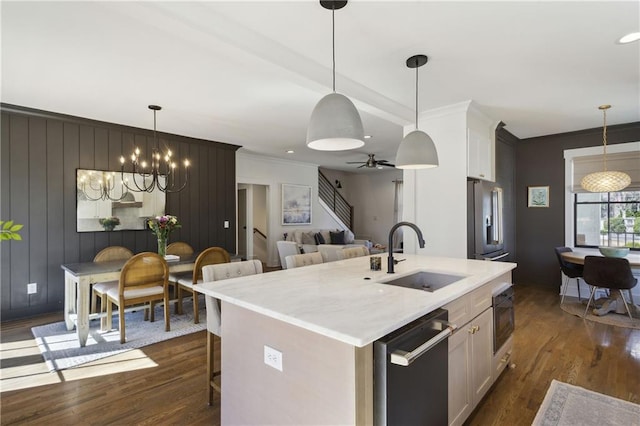 kitchen featuring dark wood-type flooring, a center island with sink, a sink, a breakfast bar area, and dishwasher