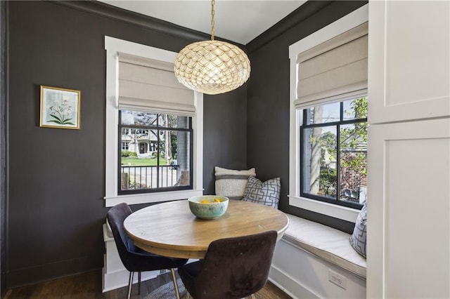 dining room featuring a wealth of natural light, baseboards, and dark wood-style flooring