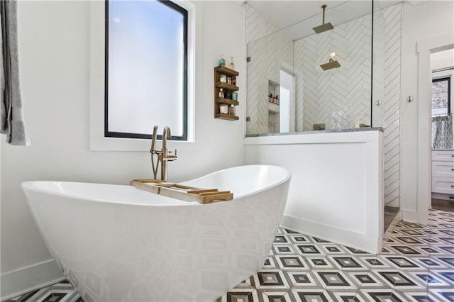 bathroom with a freestanding tub and a walk in shower