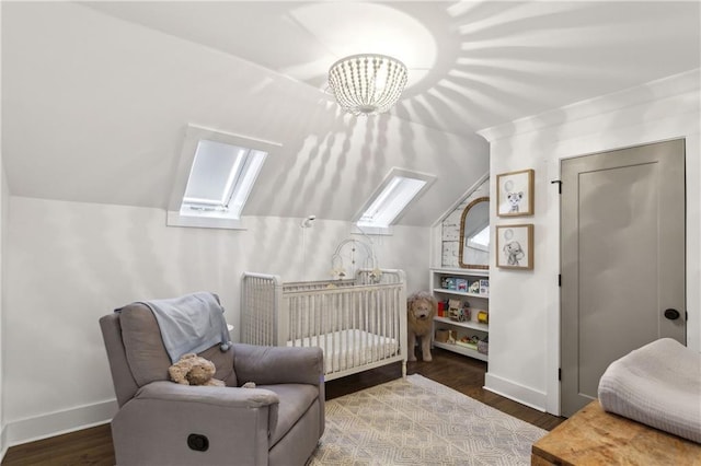 bedroom with lofted ceiling with skylight, a nursery area, wood finished floors, and baseboards