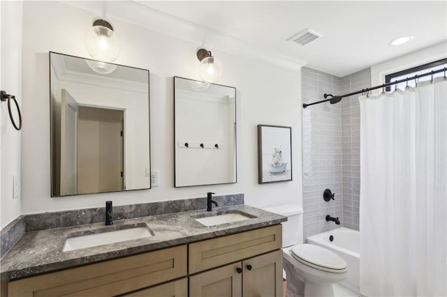 bathroom featuring double vanity, shower / bath combo, visible vents, and a sink