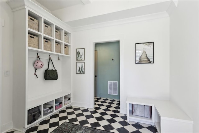 mudroom with tile patterned floors, visible vents, crown molding, and baseboards