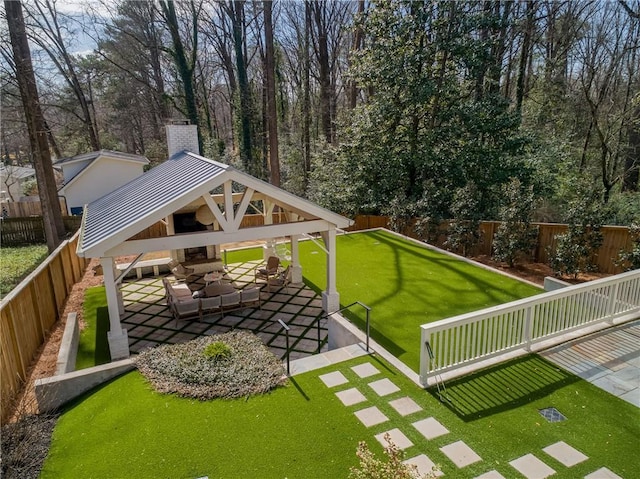 view of yard with a gazebo, an outdoor hangout area, a fenced backyard, and a patio