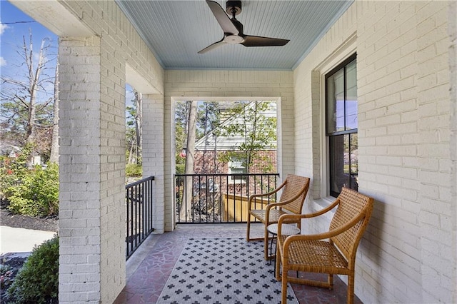 balcony with covered porch and ceiling fan