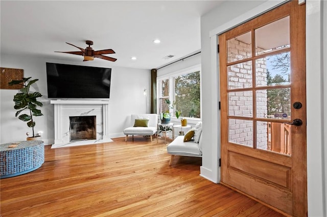 sitting room featuring a fireplace, recessed lighting, a ceiling fan, wood finished floors, and baseboards