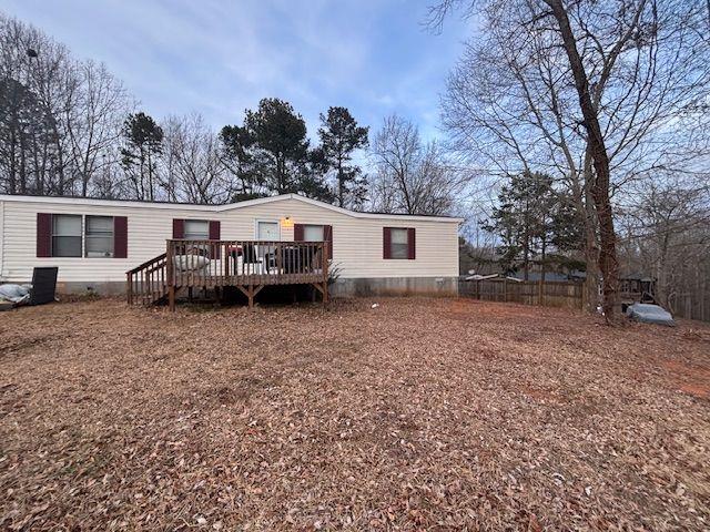 rear view of house featuring a deck