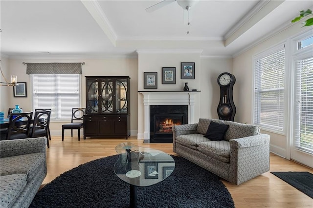 living room featuring light hardwood / wood-style flooring, ceiling fan, and a healthy amount of sunlight