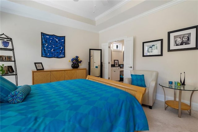 bedroom featuring crown molding, ceiling fan, ensuite bathroom, and light colored carpet