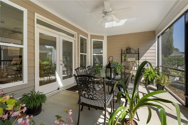 sunroom with french doors, a skylight, and ceiling fan