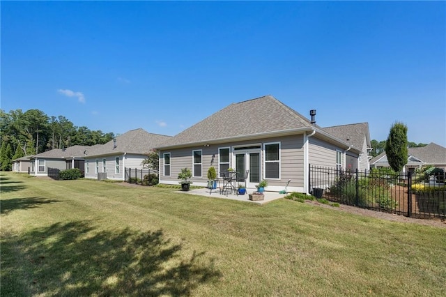 back of property with a yard and a patio