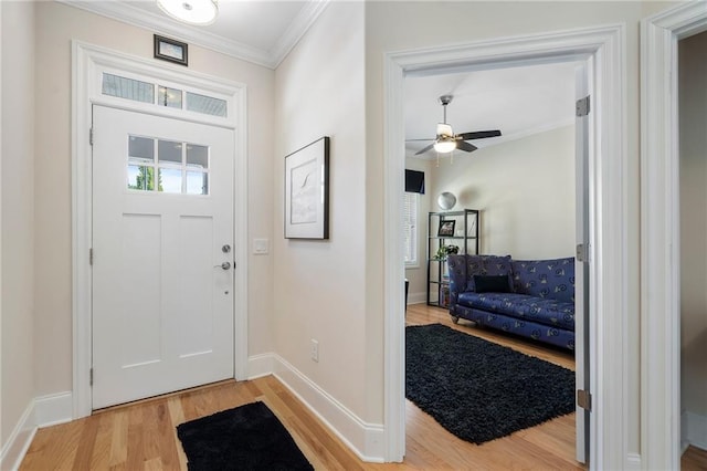 entryway featuring light hardwood / wood-style flooring, ceiling fan, and ornamental molding