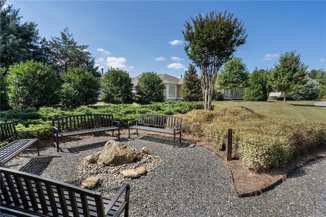 view of home's community featuring a fire pit and a lawn