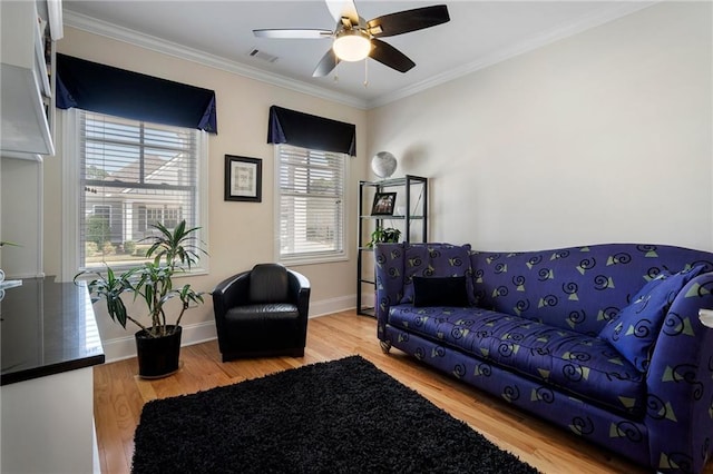 living room with ceiling fan, ornamental molding, and hardwood / wood-style flooring