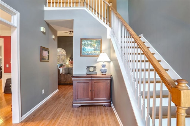 stairway with a high ceiling and hardwood / wood-style flooring