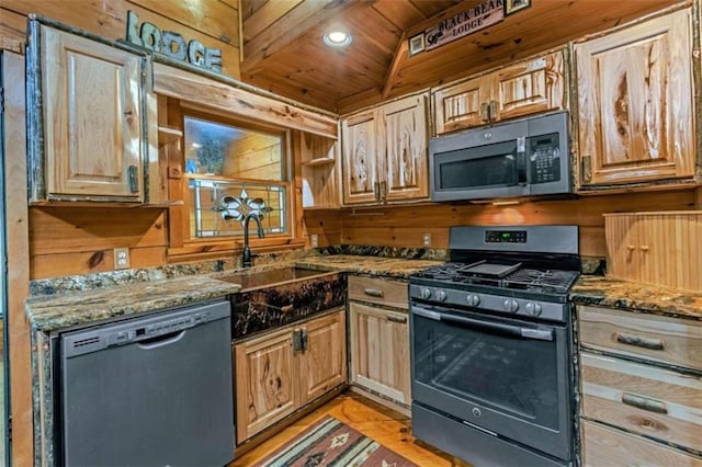 kitchen with wooden walls, appliances with stainless steel finishes, wood ceiling, sink, and dark stone counters