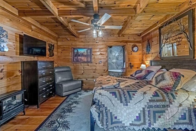 bedroom with wooden ceiling, beamed ceiling, hardwood / wood-style flooring, and wooden walls