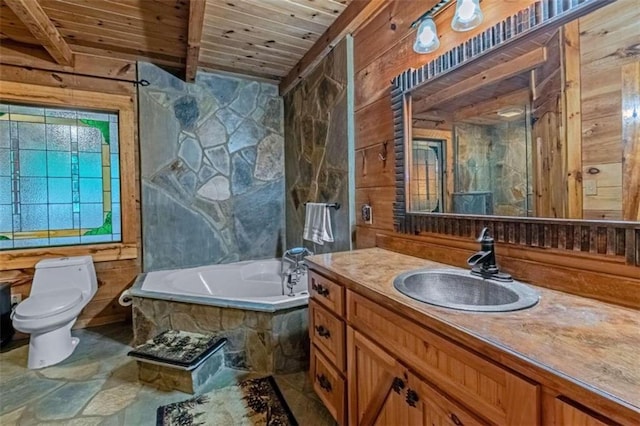 bathroom with tiled tub, toilet, vanity, wooden ceiling, and beam ceiling